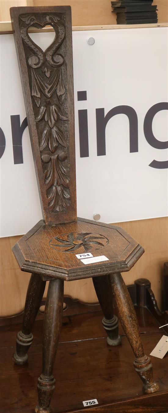 An oak carved milking stool, H.82cm